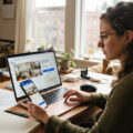 Renter checking a Zillow listing on a laptop to verify it is legitimate